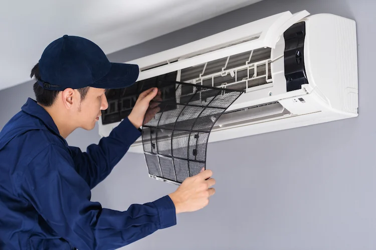 Technician servicing AC